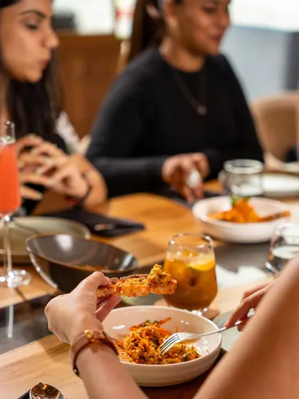 A snapshot of a perfect evening. Guests enjoying a meal, with our inventive cocktails and flavourful dishes creating a relaxed and happy atmosphere.