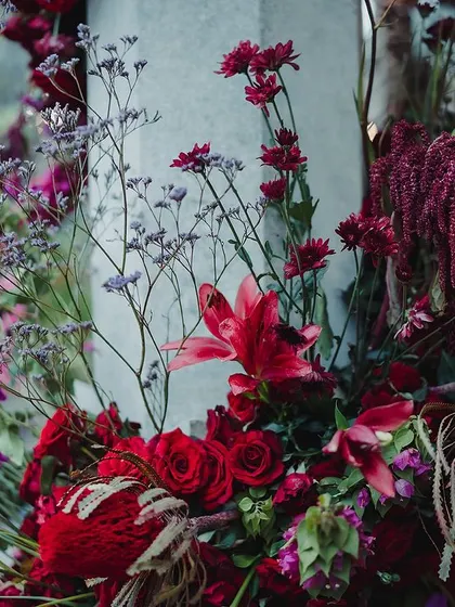 A detailed look at the rich, moody floral arrangements for a traditional Bunt ceremony. We use multiple layers of flowers in deep reds and purples, like roses and lilies, to create depth and texture in our color schemes.
