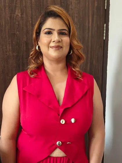 A flawless makeup look for this client in a chic red outfit. The makeup is clean and polished, enhancing her natural beauty.