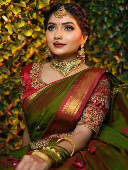 This image captures the elegance of the final bridal look, with the perfectly pleated pallu resting on the shoulder and the rich fabric falling gracefully.