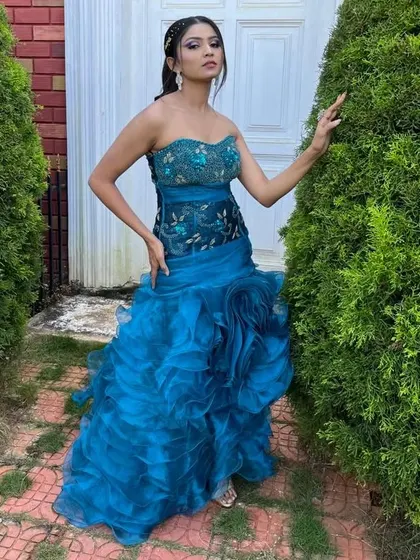This strapless blue ruffled bodycon gown is a modern and stylish choice. The tiered ruffles on the skirt add texture and movement, making it a unique piece for any event.