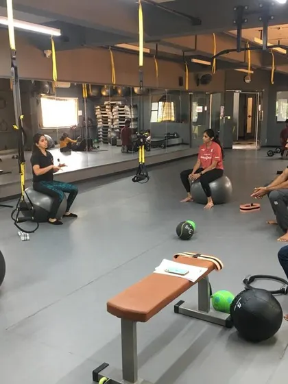 Students use stability balls for a core and balance workout. We teach how to use various functional training tools to create diverse and effective client programs.