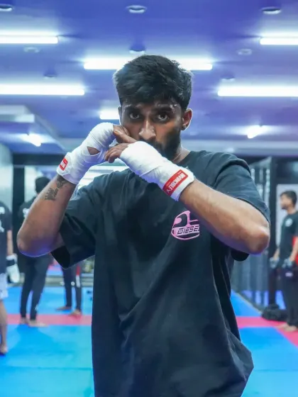 A fighter in a ready stance, with hands wrapped and prepared for action. We emphasize proper form in every aspect of boxing.