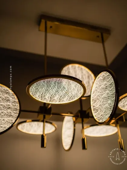 This artistic chandelier is composed of multiple circular discs with a unique woven texture. The layered arrangement and soft backlighting create a beautiful interplay of light and shadow, making it a captivating centerpiece.