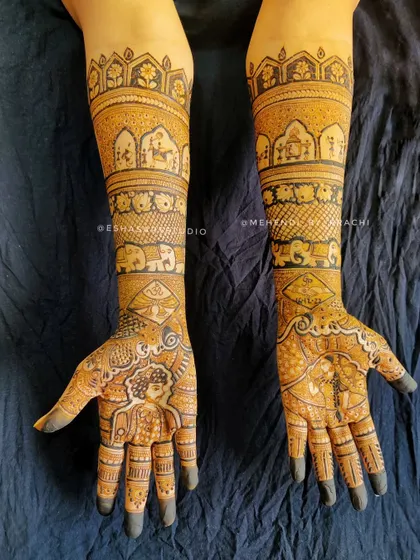 A full bridal mehndi featuring a sweet bride figure on the palm. The arms are adorned with bands of elephants and traditional Indian motifs, telling a complete wedding story.