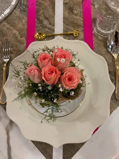 This elegant pink ribbon-themed tablescape is a perfect example of how I create a special mood for any occasion. The delicate floral centerpiece on the scalloped plate, paired with gold and silver cutlery, sets a tone of grace and celebration.