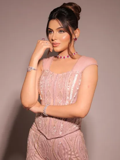 The corset trend, reimagined with timeless elegance. This blush pink, fully embellished sharara set with sleeves brings a blend of modern allure and classic charm.