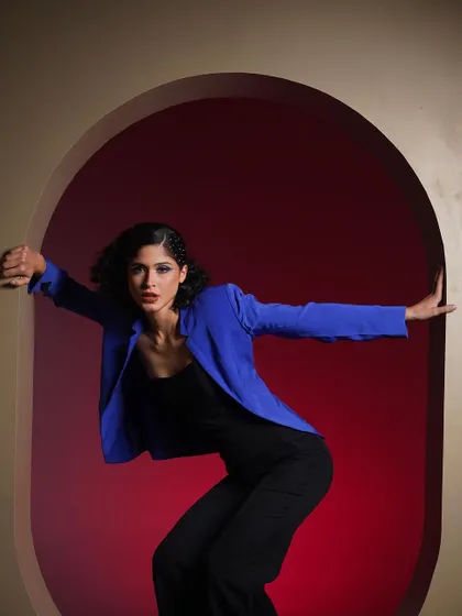 A strong, symmetrical pose framed by the arch. The red and blue color story in this series shows my ability to create a cohesive editorial narrative.
