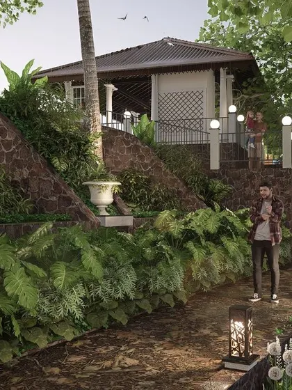 This image shows the use of curved retaining walls and terraced planting to manage the steep slope at Nilaya Residence. Custom-designed bollard lights provide gentle, ambient illumination along the natural walking paths, enhancing the garden's atmosphere at night.