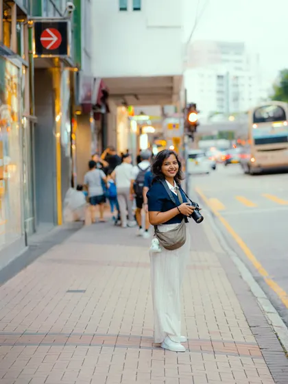 This is me in my element, exploring the streets of Hong Kong with my Nikon camera. Being a travel filmmaker means I'm always ready to capture a story, whether I'm on a planned shoot or just walking down the street.