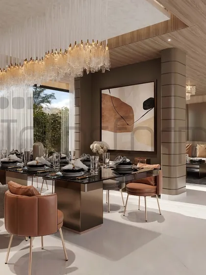 This dining area is a symphony of style, designed as part of an open-plan living space. The long, cascading chandelier defines the dining zone, while the mix of leather and fabric chairs adds textural interest.