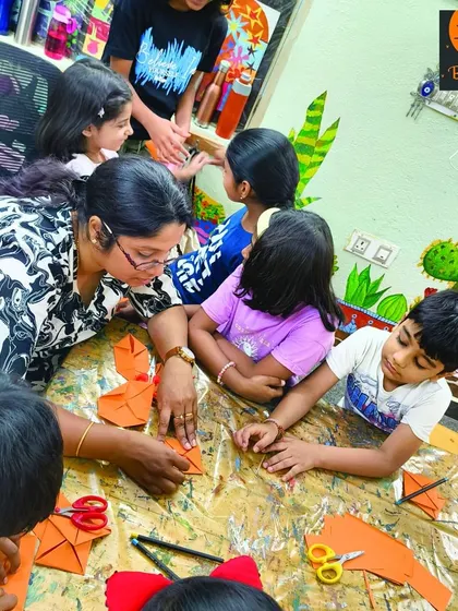 A group of students gathered around the table for a paper craft activity. Our instructors ensure everyone understands the steps and feels included in the fun.