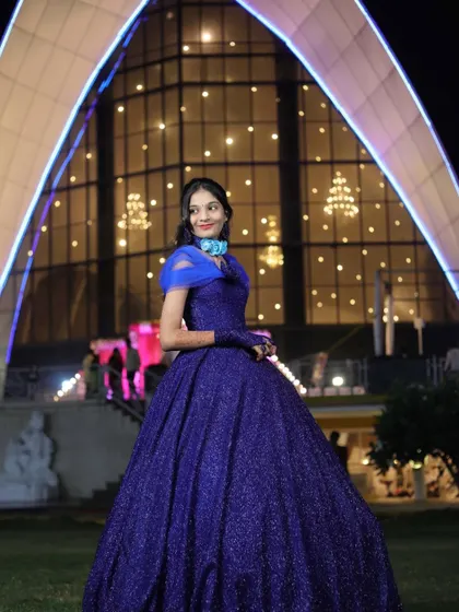 The stunning blue gown against a beautiful backdrop. Perfect for a grand evening event or reception.