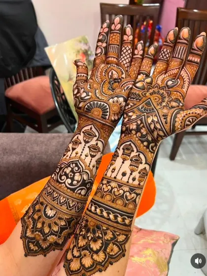 A festive design featuring hanging lanterns (kandeel) and bold floral work, perfect for a bride who wants a bright and celebratory look.