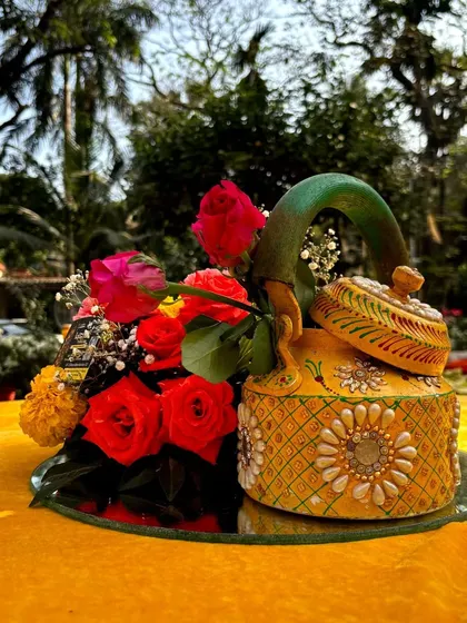 Another hand-painted kettle, this one in yellow, used as a unique and artistic centerpiece for a Mehendi event.