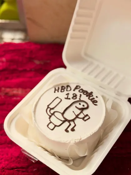 A cheeky and fun 18th birthday bento cake with a simple but hilarious cartoon drawing. It's a great example of a minimalist but impactful custom design.