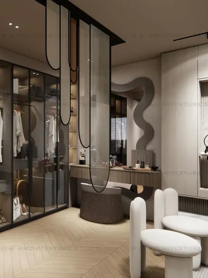 The dressing area of the day room, featuring a walk-in glass wardrobe and a stylish vanity separated by a curvy hanging partition.