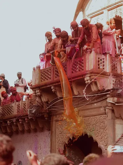 A vibrant collection of images from the Holi celebrations in Braj, specifically Nandgaon. This series captures the pure ecstasy of the festival, with portraits of devotees, men dressed as gopis, and crowds dancing in a cloud of colors.