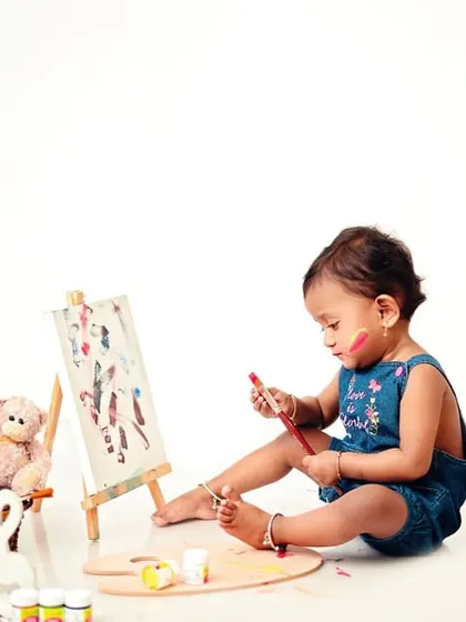 Caught in the act of creating a masterpiece. I use non-toxic, baby-safe materials to ensure these sessions are as safe as they are fun.