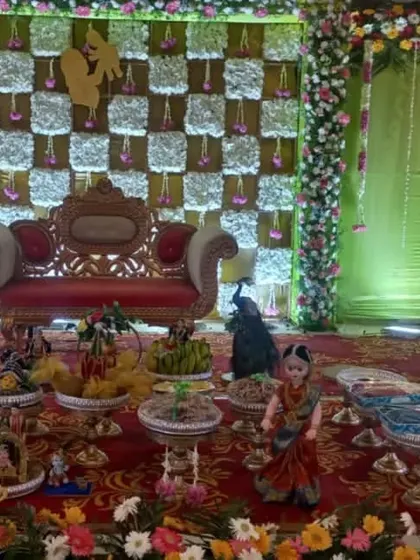 A platter display with peacock figures and a checkered green backdrop.
