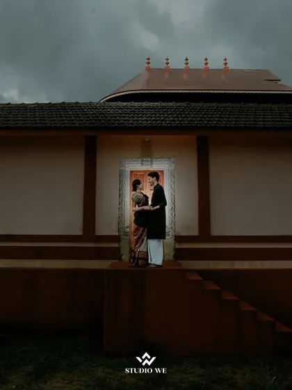 A beautifully framed shot of a couple standing in a doorway of a traditional house. This image blends architecture, culture, and romance into a single, powerful frame.