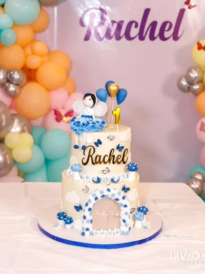 The fairy-themed cake looking stunning amidst the party decorations. It's so rewarding to see my creations as the centerpiece of such beautiful events.