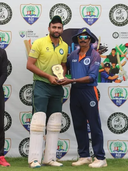 A batsman receives his award, fully padded, right after his match-winning innings. We conduct timely and efficient presentations.