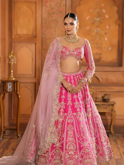 A full-length shot of the bride in her magnificent pink lehenga. The makeup provides a radiant focal point, tying the entire regal look together.
