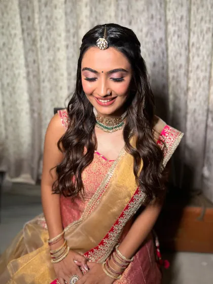 A close up of Jhanvi's eye makeup. The pop of pink adds a fun and modern twist to her traditional attire.
