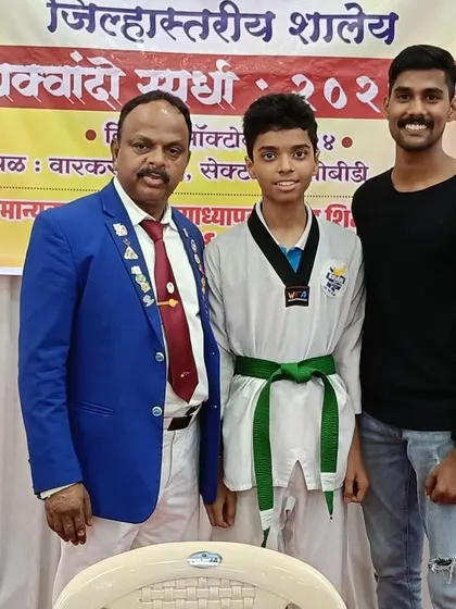 Another one of my students standing proud with officials at a district level Taekwondo competition. He showed great technique and spirit on the mat.