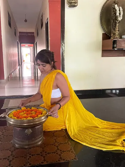 For my graduation day from advanced teacher training, I chose to wear yellow, the color of knowledge, the Guru, and light. Here I am arranging flowers, a small act of devotion and gratitude.