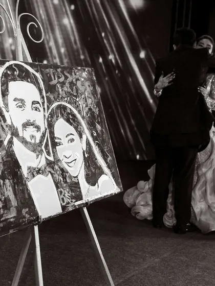 A special moment during the reception, where the couple embraces next to a live-painted portrait of themselves. This is a unique and artistic touch that serves as both entertainment and a lasting keepsake.