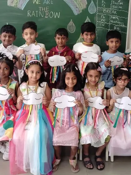 A full class of students with their handmade rainbow crafts, celebrating a day of colorful learning.