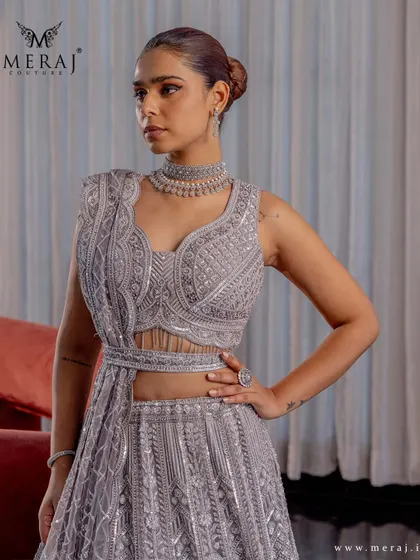 A close-up of the silver-grey lehenga, highlighting the intricate sequin detailing and geometric embroidery on the blouse.