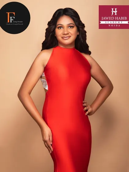 A portrait of a model in a red dress, with makeup and hair by our students, showcasing their ability to create glamorous runway looks.