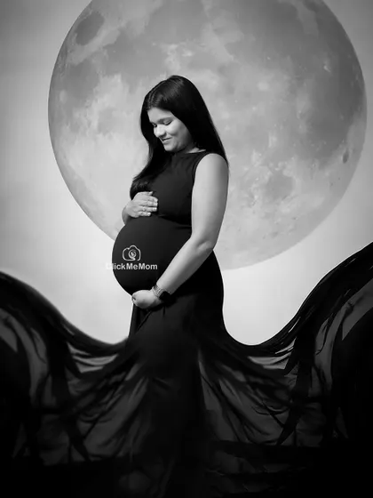 Another beautiful pose from my moon and stars series, captured in stunning black and white. This image highlights the mother's serene expression as she cradles her bump.
