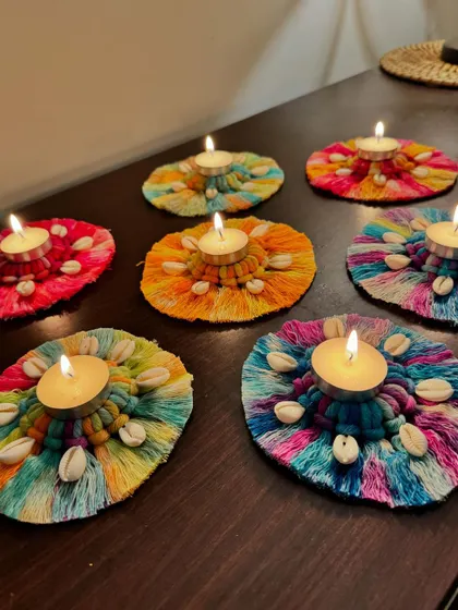 My colorful macrame and shell tea light holders lighting up a table for Diwali.