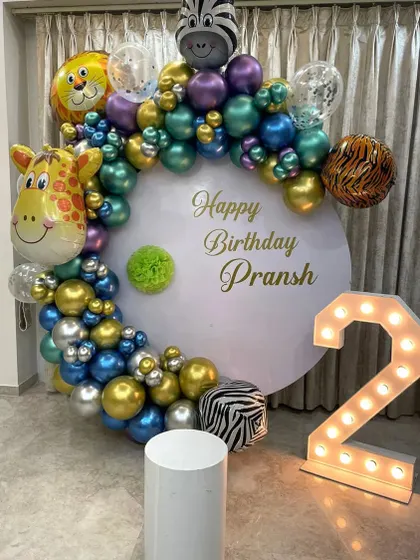 A jungle-themed second birthday with metallic balloons and large animal foil balloons.