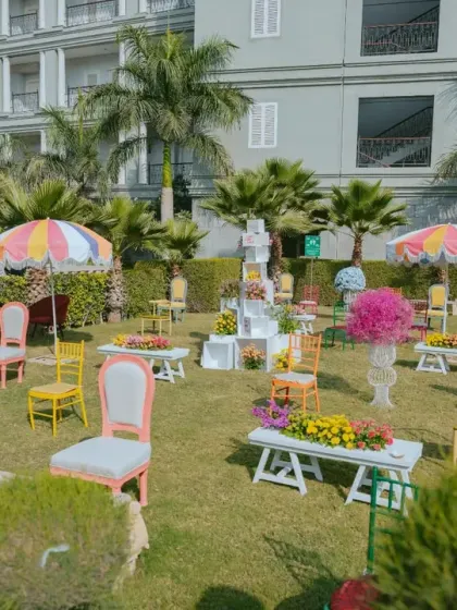 A whimsical 'memory lane' installation with chairs of different colors and styles, each representing a special moment for the couple.