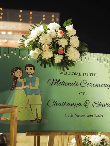 A charming welcome sign for Chaitanya and Shivani's Mehendi ceremony, featuring a sweet illustration of the couple.