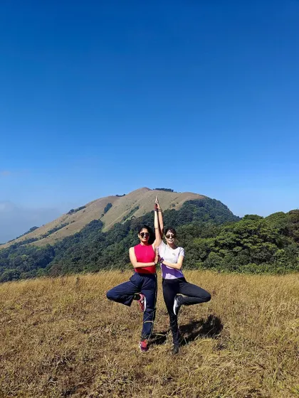 Finding balance together in Vrikshasana, the tree pose. Practicing with a partner can help you find stability you didn't know you had.