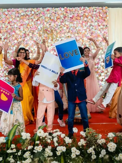 We love using small, fun props to make an event more interactive. Here, kids and adults hold up personalized signs to celebrate the couple, adding to the grandeur of the evening.