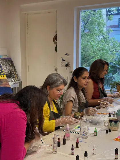 A group of friends enjoying an alcohol ink workshop together. It's a perfect activity for a fun and colorful get-together.