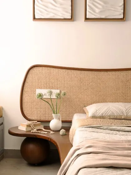 The master bedroom features the custom-designed cane headboard, which brings a natural, textural element to the space. A built-in window seat with storage underneath provides a cozy reading nook.