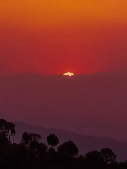 A deep red sunset over the rolling hills of Ranikhet. I love capturing these moments when the sky feels heavy with color, just before the day ends.