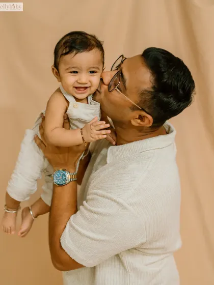 A sweet kiss from dad. These are the tender, candid moments that beautifully illustrate the father-child bond.