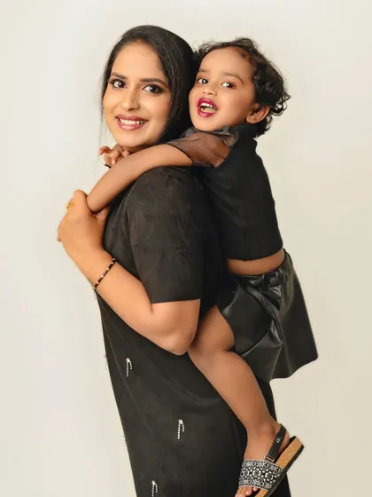 A playful piggyback ride in the studio. This photo captures the fun and loving relationship between a mother and her daughter in a simple, clean setting.