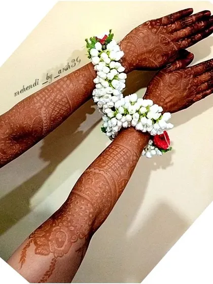 The beauty of a mature henna stain, complemented by traditional floral jewelry. This is the picture-perfect look for any bride.