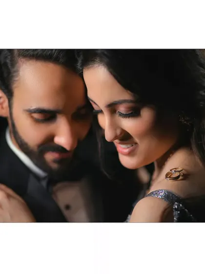 A close, intimate portrait where the couple's connection is the main focus. The soft lighting and their gentle expressions tell a story of quiet love.