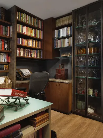 The book-lined study in the Courtyard Home is a sanctuary for reading and writing. Custom shelving houses an extensive library, while a functional desk and comfortable seating make it a well-used and beloved space.